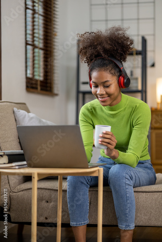 An American teenage woman is in the living room, she is spending her weekends at home playing social media and watching movies. The concept of living on vacation.