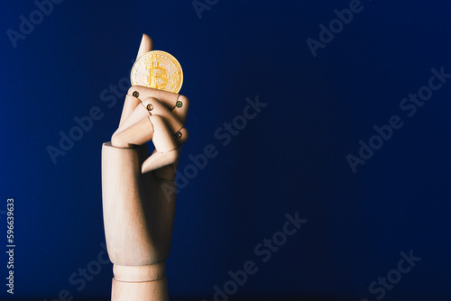 Artificial hand holding one bitcoin on white paper background. Virtual money concept and Financial growth concept. Trading Mining of bitcoins.