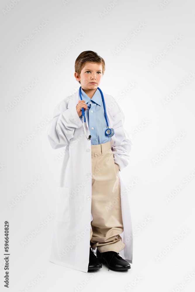 The doctor will see you now. Studio shot of an adorable little boy dressing up as a doctor. The doctor will see you now. Studio shot of an adorable little boy dressing up as a doctor.