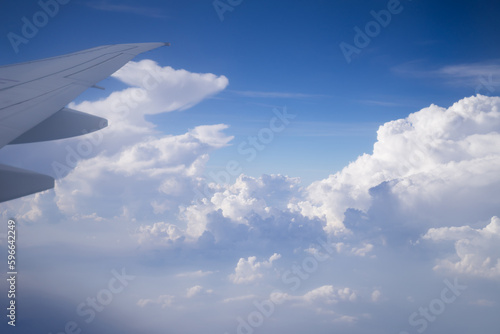Airplane wing in cloudy sky Airplane flying over landscape with clear sky Air vehicles from a seated person's point of view