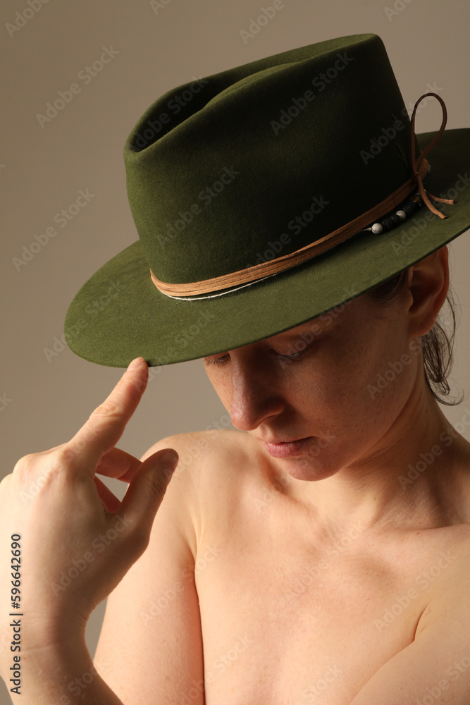 Close-up of confident young woman wearing green hat. Vertical mock-up. Close-up of confident young woman wearing green hat. Vertical mock-up.
