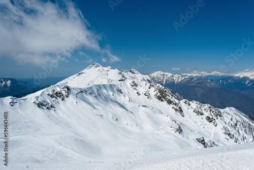 Beautiful snow capped peaks of the Caucasus Mountains. Rosa Khutor Alpine Resort in Sochi. Russia © Ms VectorPlus