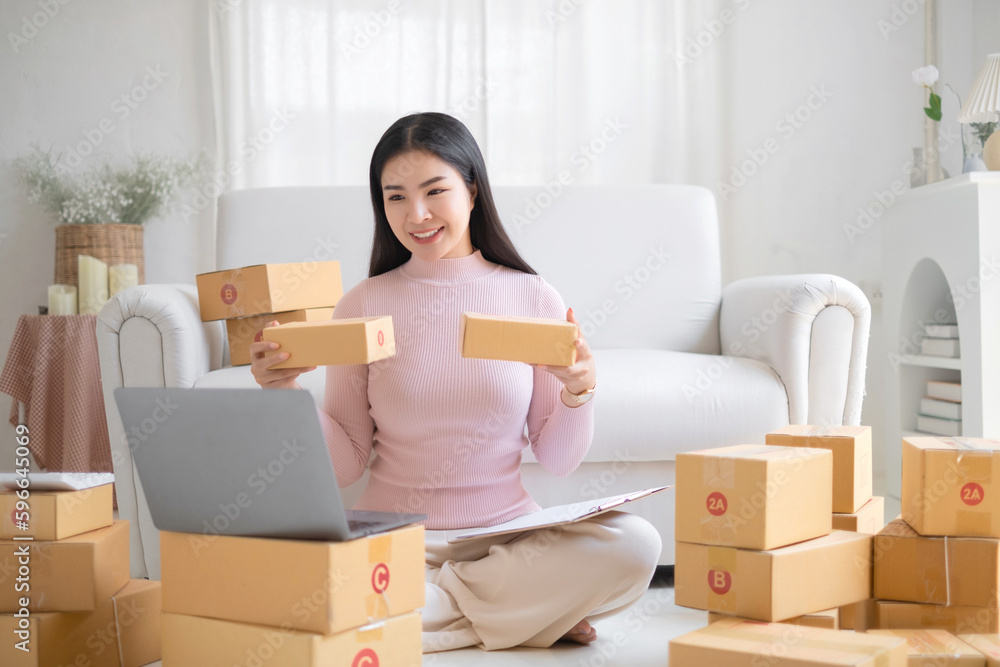 Entrepreneur, small business, SME, freelance woman working from home with lots of boxes on the side. Entrepreneur, small business, SME, freelance woman working from home with lots of boxes on the side.