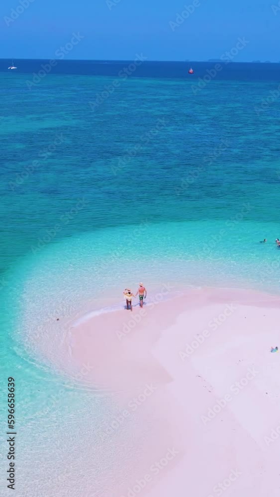couple of men and women on the beach of Koh Lipe Thailand, drone aerial view over the white sand tropical beach couple of men and women on the beach of Koh Lipe Thailand, drone aerial view over the white sand tropical beach