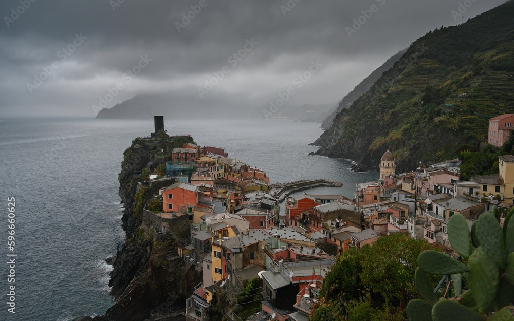 Long exposure panorama of Vernazza at sunrise, with dark clouds and fog (Cinque Terre)