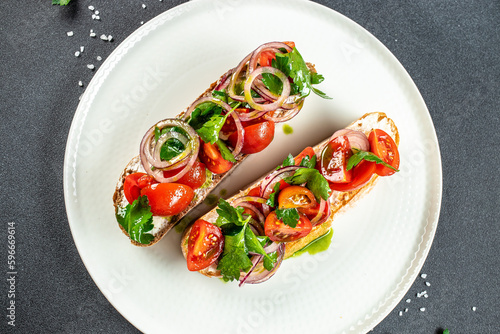 Traditional Italian bruschetta cheese, tomatoes and basil, place for text, top view