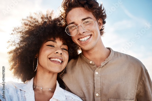 Принти на полотні Portrait of a young mixed race couple enjoying a day at the beach looking happy and in love