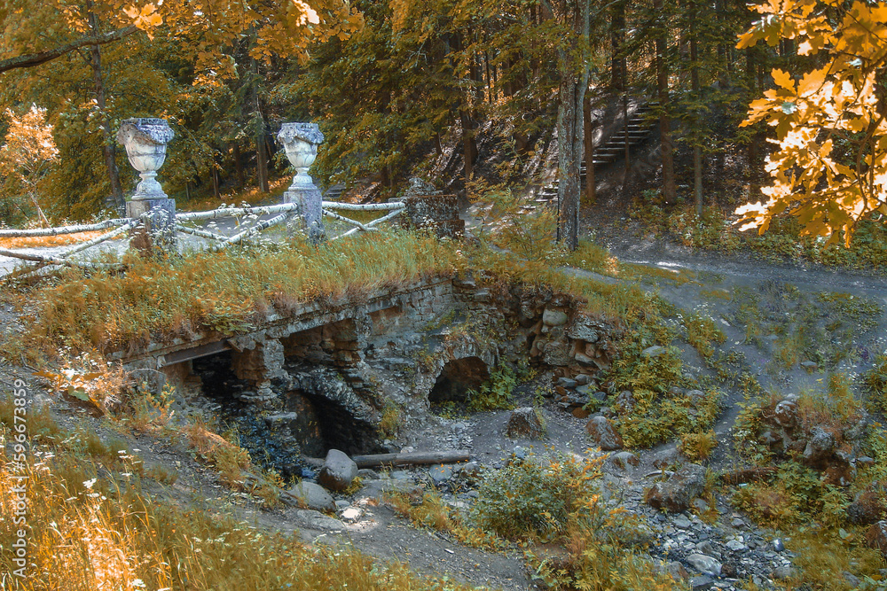 An abandoned cascade of ruins in Pavlovsk, Russia. Autumn landscape with ancient architecture. An abandoned cascade of ruins in Pavlovsk, Russia. Autumn landscape with ancient architecture.