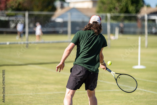 Amateur playing tennis at a tournament and match on grass in Europe  © William
