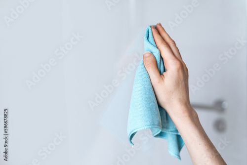 Woman hand holding a blue microfiber cleaning cloth photo