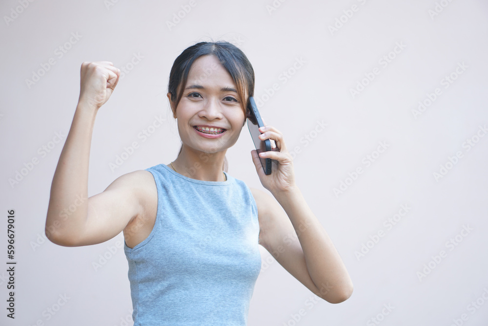 Woman looks at phone and rejoices from more business profit Woman looks at phone and rejoices from more business profit
