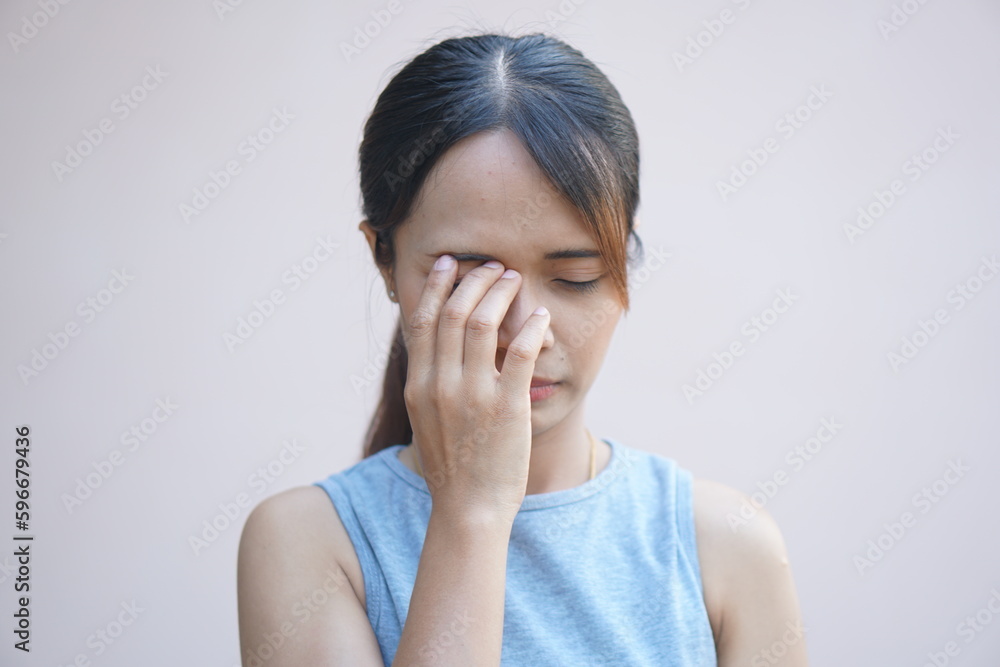 Asian woman having pain in the eye area Asian woman having pain in the eye area