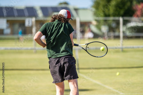 Amateur Tennis player, playing tennis at a tournament and match on grass in Europe  © William