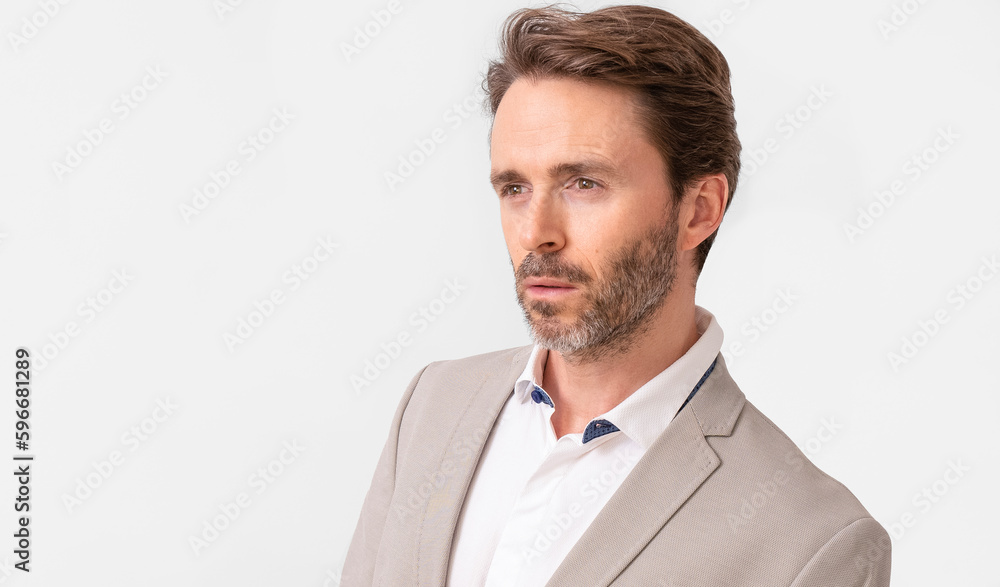 Handsome male model posing wearing a silver suit and a white shirt. Handsome male model posing wearing a silver suit and a white shirt.