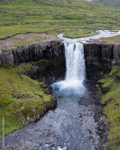 Drone Aerial of Kerlingarfoss Waterfall near Olafsvik on Iceland s Snafellsnes peninsula. High quality photo. Beautiful waterfall with the Snaefellsjokull Volcano in the background.