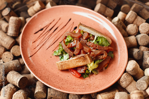 Salad with salmon, toast and mix Salad leaves on the background of wine corks