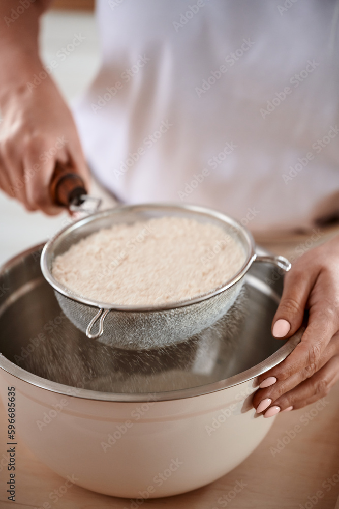 Woman Sifting Flour with Bowl and Sieve Woman Sifting Flour with Bowl and Sieve