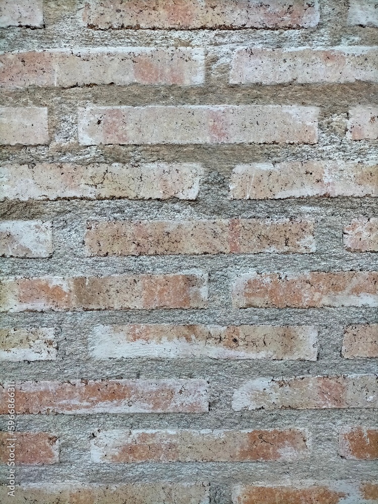background of exposed brick wall in red earth color with a thin layer of natural white from the passage of time with a cement seam background of exposed brick wall in red earth color with a thin layer of natural white from the passage of time with a cement seam