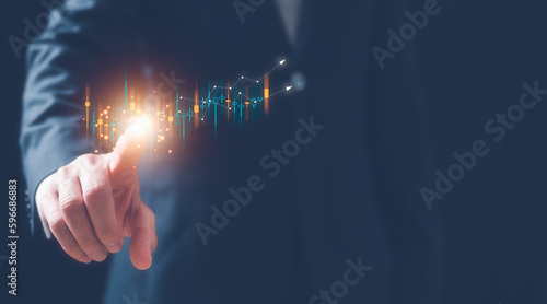 financial and investment plan concept, businessman pointing at virtual graph and arrow moving up, marketing business growth strategy