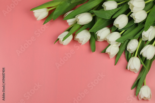 Beautiful bouquet of white tulip flowers with card on pink background, space for text