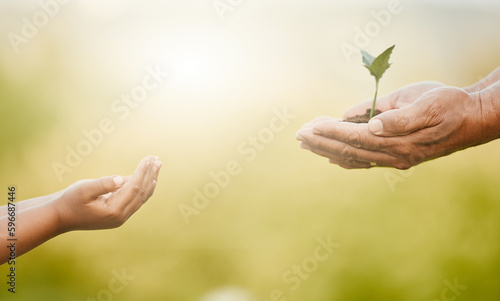 Sharing is caring. Shot of an unrecognizable little boy and his grandfather holding plants growing out of soil. © Kirsten D/peopleimages.com