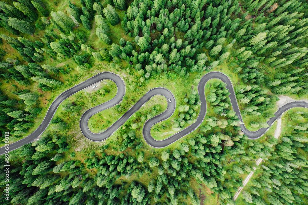 Cars on driveway of famous Snake Road surrounded by forests and meadows. Serpentine Snake Road across Giau Pass surrounded by mountain ranges in summer forest Cars on driveway of famous Snake Road surrounded by forests and meadows. Serpentine Snake Road across Giau Pass surrounded by mountain ranges in summer forest