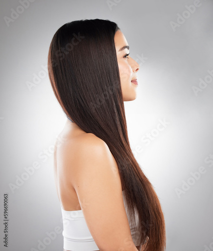 Good mood stems from a good hair day. Studio shot of a beautiful young woman showing off her long silky hair against a grey background.