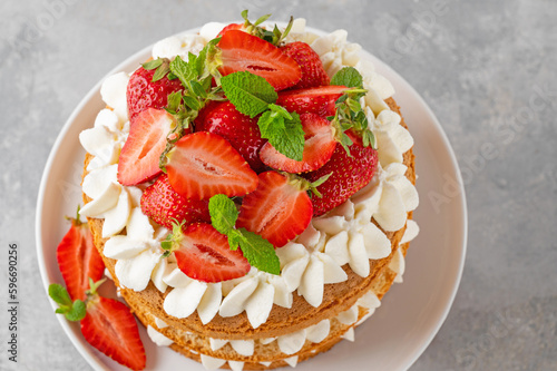 Strawberry cake, vanilla sponge cake with cream cheese and fresh strawberries. Summer cake. Selective focus.
