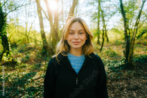 Portrait of attractive caucasian woman hiking in a forest.