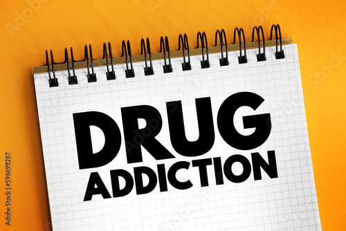Drug addiction text on notepad, concept background photo
