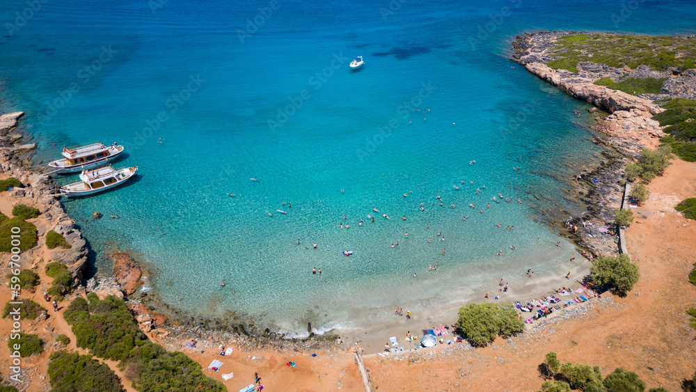 Aerial view of a small beach and clear, blue ocean on the Greek island of Crete