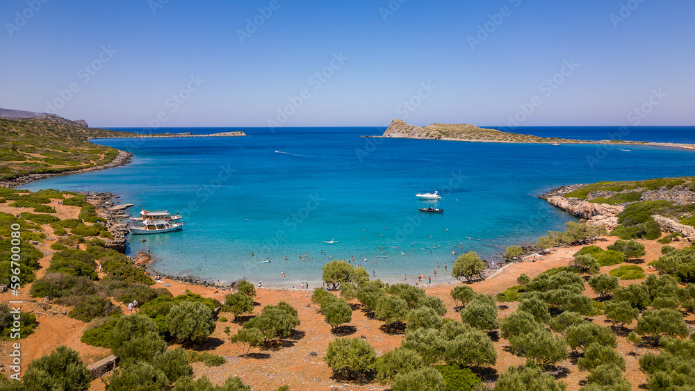 Aerial view of the clear waters and hot, dry coastline at a small beach on the Greek island of Crete