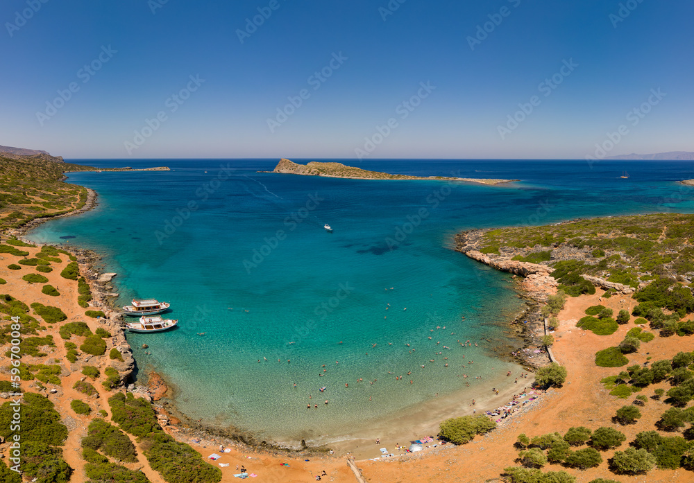 Aerial view of the clear waters and hot, dry coastline at a small beach on the Greek island of Crete