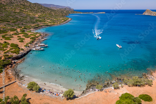 Aerial view of a small beach and clear, blue ocean on the Greek island of Crete photo