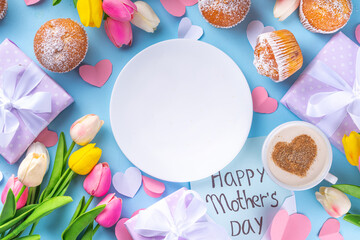Mother's day holiday greeting card. Mother's Day morning breakfast with a cute surprise background, with gift boxes, cupcakes, coffee mug, heart decor, tulips and flowers, Happy Mother's Day letter