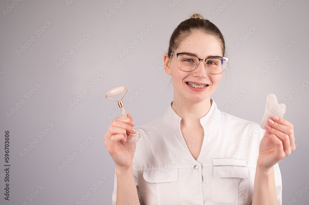Beautician doctor holding gouache scraper and roller. Beautician doctor holding gouache scraper and roller.
