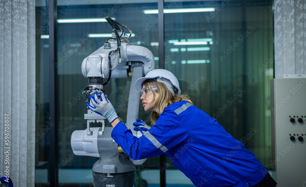 Engineer factory industry wearing safety uniform work and checking system of the welding robots for welding steel electrical by control system robot automate for industry manufacture concept. Engineer factory industry wearing safety uniform work and checking system of the welding robots for welding steel electrical by control system robot automate for industry manufacture concept.