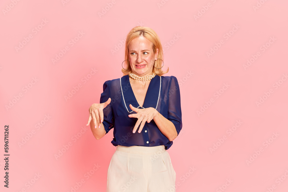 Portrait of adorable woman wearing elegant costume expressing disgusting with hands and looking away over pink background. Dislike Portrait of adorable woman wearing elegant costume expressing disgusting with hands and looking away over pink background. Dislike