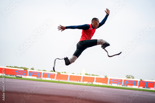 athlete runner physically disabled run on track of stadium photo