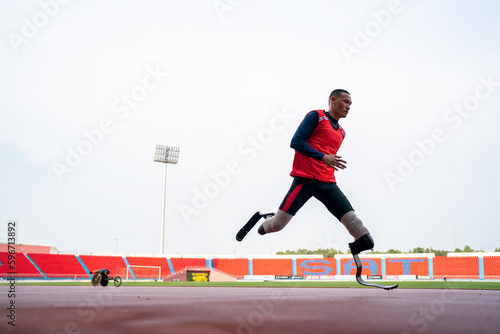 athlete runner physically disabled run on track of stadium