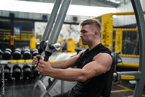 Man doing weight lifting exercises inside the gym