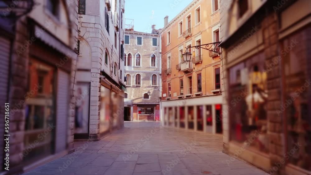 Motion along empty city street with stores in old buildings Motion along empty city street with stores in old buildings