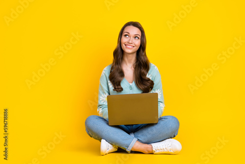 Full length body cadre of young cheerful satisfied lady brown curly hairdo dreamy look empty space future project isolated on yellow color background © deagreez