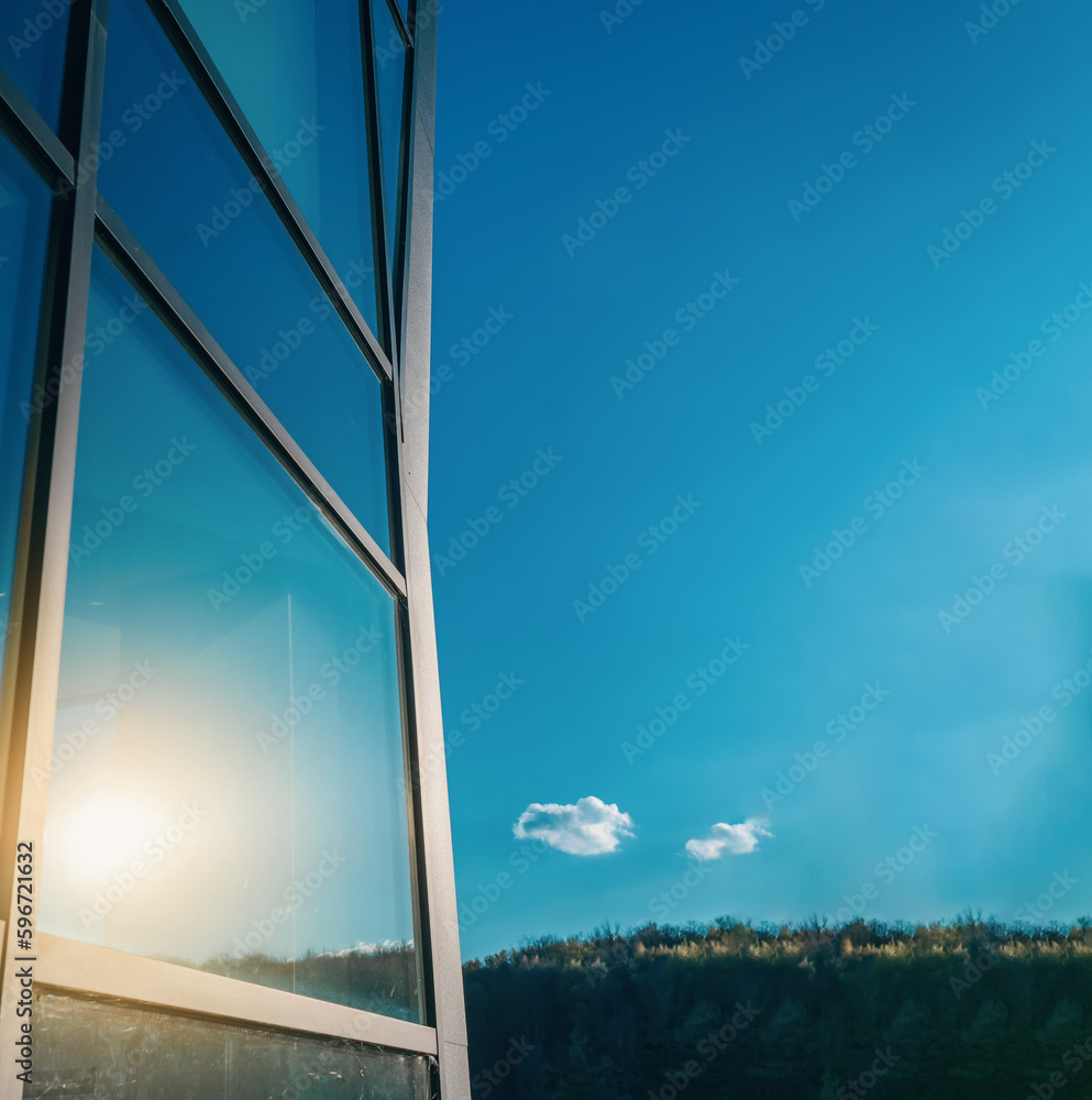 Fototapeta premium Glass windows of a modern building. Sunlight is reflected in the glass