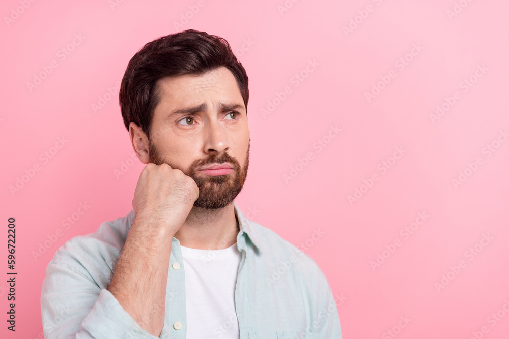 Photo of upset stressed man wear turquoise shirt arm cheek looking empty space isolated pink color background