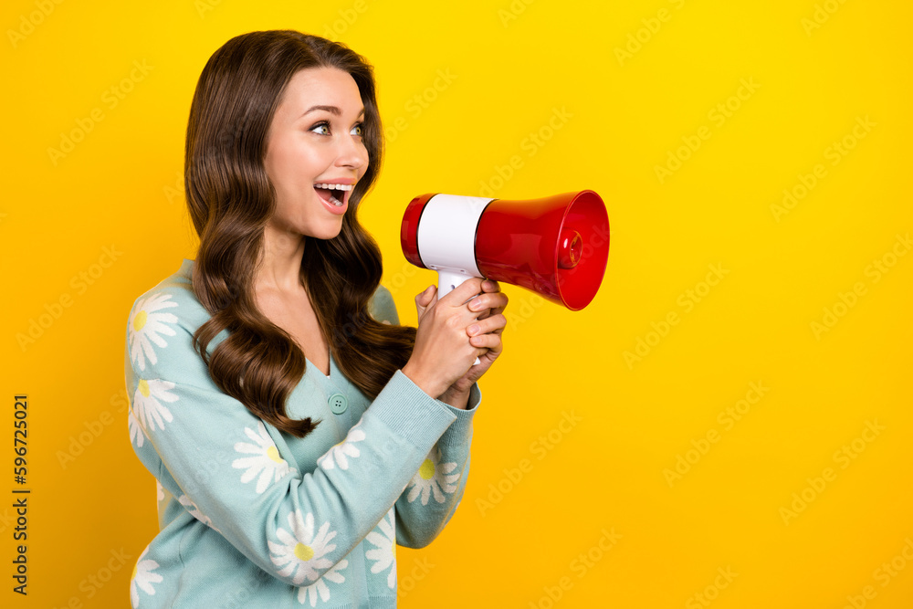 Photo of young beautiful woman hold loudspeaker voice screaming looking empty space shopping proposition offer isolated on yellow color background Photo of young beautiful woman hold loudspeaker voice screaming looking empty space shopping proposition offer isolated on yellow color background