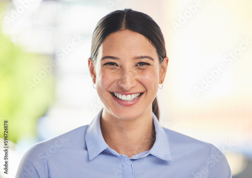 Closeup portrait of a happy mixed race smiling female working. Face shot of a cheerful positive hispanic woman enjoying her corporate office job while wearing formal clothes and showing her teeth