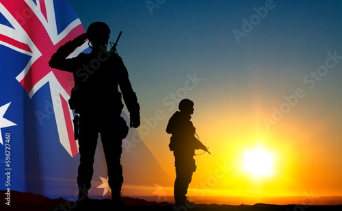 Silhouettes of Soldiers with Australian flag on background of sunset