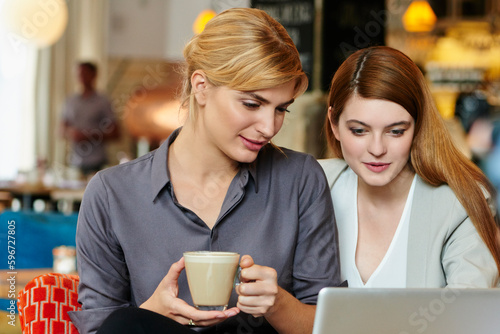 The design duo. Cropped shot of two attractive young businesswomen working in a coffee shop.