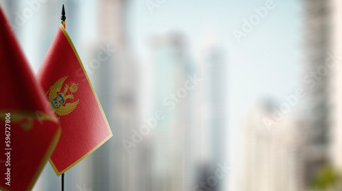 Small flags of the Montenegro on an abstract blurry background